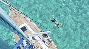 Man swimming by yacht